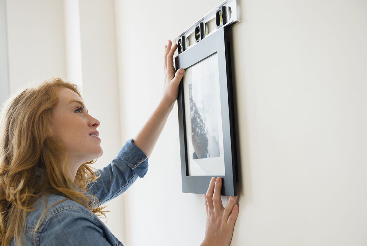 Lady putting wall art